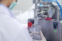 Image Man at facility filling container from machine.