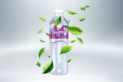 Image A bottle of water with leaves flying around it.