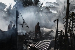 Image Fire fighters with building rubble after fire