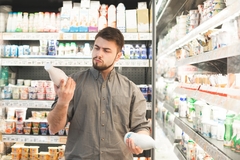 A shopper reads food labels in the supermarket.