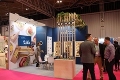 A group of people in at Colpac's booth