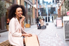 Image Woman sitting outside eating a healthy snack.