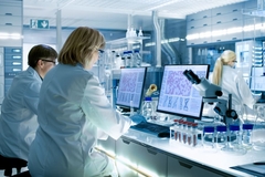 Three scientists sitting in a lab.