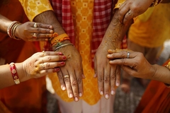 Women engaging in Ayurvedic ritual with tumeric