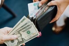 Image People exchanging money from their wallets.