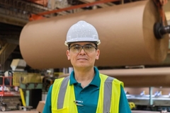 Image A person wearing a safety vest and a hard hat.