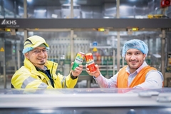 Image two men in factory drinking carlsberg