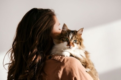 Image A woman holding a cat.