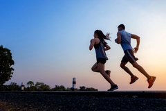 Image man and woman running around dusk