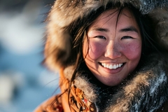 Image Inuit woman smiling in furry clothes