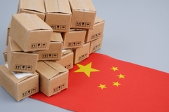 Image A stack of paper boxes next to a Chinese flag