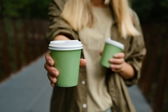 Image holding out coffee cup