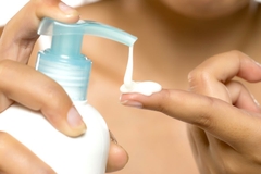 Image finger pressing down tube with cream