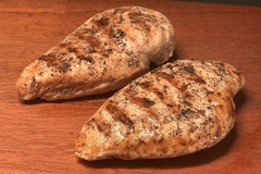 Image Chicken and plant based whole cut meat on a wooden table.