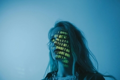 A woman with code on her face.