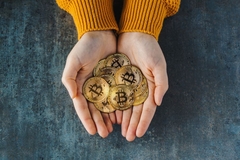 hands holding bitcoins in palm