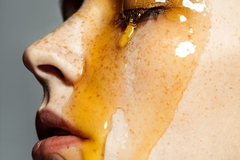 Image Honey dripping down a girls face.