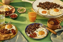 Image plant based steak bites in plates with eggs and juices on the table