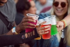 A group of people holding cups of drinks