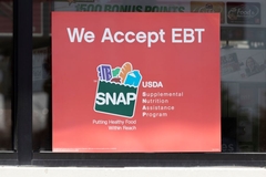 SNAP poster outside store window