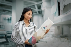 Image Woman holding sealed bedding package