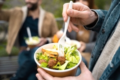 Image Eating salad from takeaway container.