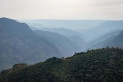Image A mountain range with trees.