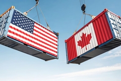 Image Containers with US and Canadian flags hanging in the air.