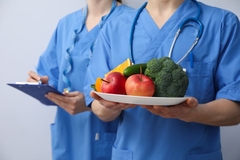 Image Doctors with a plate of vegetables.
