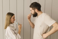 Image Woman and man brushing their teeth