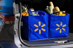 A Walmart grocery bags in the back of a car