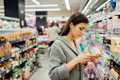 Women checking food and beverages in the supermarket.