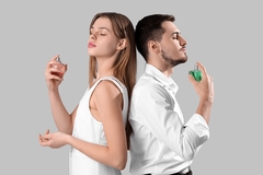 Man and woman applying fragrances.