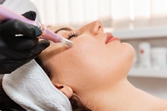 Image Cosmetics applied to woman's face with microneedle.