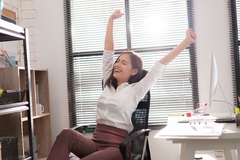 worker happily stretches in office