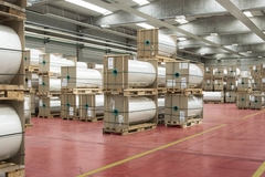 Image A warehouse full of rolls of material.