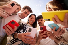 Image Diverse group young people in circle staring in surprise at cell phone screen