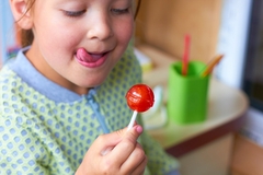 Image A child eating candy.