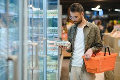 ShShopper buying eggs in the supermarket.