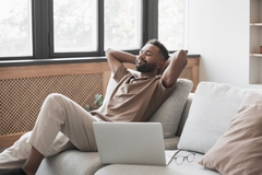Image Relaxed man sitting on a sofa