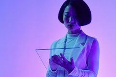 Image Futuristic scientist working on glass tablet in purple room