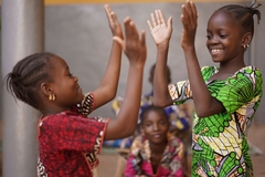 Image two african girls high five