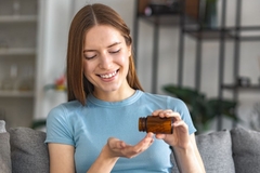 Image Woman taking probiotic capsule for IBS