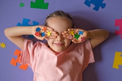 Image Autistic child playing with a puzzle