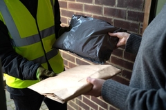 Image A person exchanging two bags with a person
