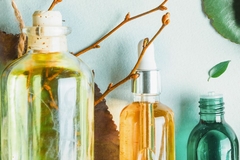 Three bottles with leaves in the background.