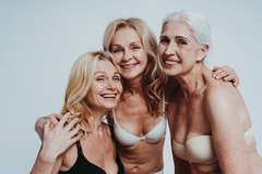 Image Menopausal women hugging and smiling.