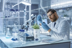 Image Scientists conducts experiment with plant
