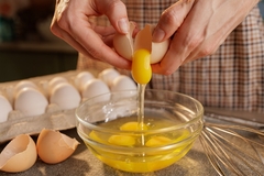 Image An egg being cracked open.