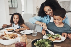 Image A family eating food at a table.